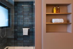 a bathroom with a shower with a glass shower backdoor at Oceania Saint Malo in Saint Malo +31 photos