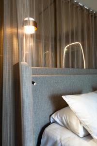 a bedroom with a bed and a window with a pillow at Oceania Saint Malo in Saint Malo