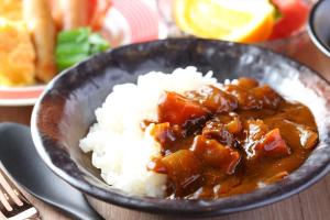 a bowl of food with rice and sauce at Almont Hotel Sendai in Sendai