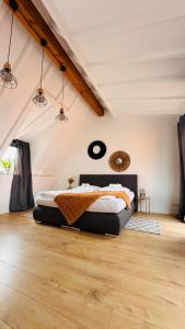 a bedroom with a large bed in a attic at AMAO-Green I 90qm I City Center I Maisonette I Rooftop Terrace I King-Size Box-Spring Beds I EuropaPark in Lahr
