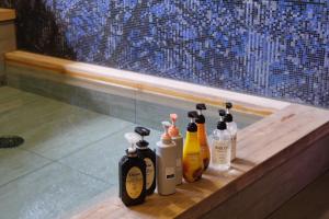 un grupo de botellas sentadas en un mostrador en un baño en Almont Hotel Sendai en Sendai