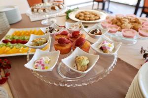 a table with a plate of cupcakes and other desserts at Baglio Dello Zingaro in Scopello