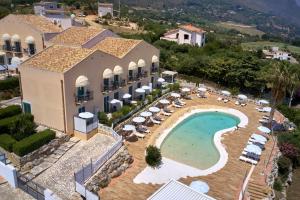 an aerial view of a resort with a swimming pool at Baglio Dello Zingaro in Scopello