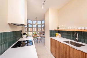 a kitchen with a sink and a counter top at Sweet Inn - Villa Olimpica Mediterranean in Barcelona