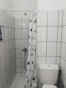 a bathroom with a toilet and a shower curtain at Hotel Maria in Skala Potamias