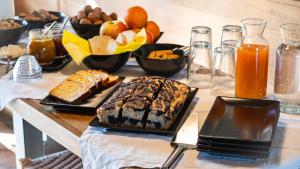 a table topped with different types of bread and fruit at Le Spine B&B sulla Via Francigena in Berceto