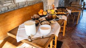 a table with food and drinks on top at Le Spine B&B sulla Via Francigena in Berceto