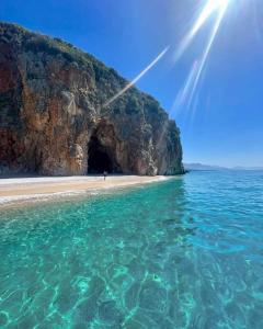 a view of a beach with a cave at Himara luxury apartments in Himare