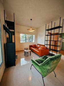 a living room with a couch and a loft bed at Beit Mema in Aḑ Ḑahr