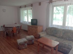 a living room with a couch and a table at Chata na samote in Prašice