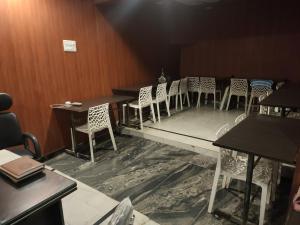 a row of tables and chairs in a room at hotel sunny international in Jammu