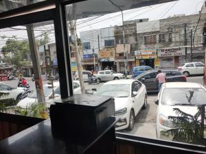 a view of a busy city street with cars parked at hotel sunny international in Jammu +20 photos