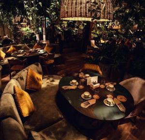 a restaurant with a round table with plates and glasses at Evropa Hotel in Bishkek