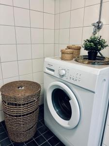 y baño con lavadora y cesta. en Cute little studio, en Oulu