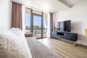 TV a/nebo společenská místnost v ubytování Apartments Mano Šventovė, By Cohost