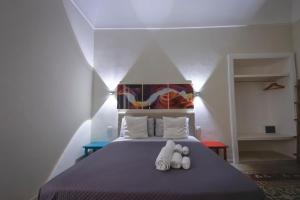 A bed or beds in a room at Sotto il Castello B&B