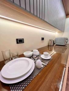 a table with white plates and cups on a table at Elite Boutique Hotel in Cairo +37 photos