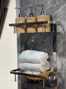 a stack of towels on a shelf in a bathroom at Puluong Valley Home in Thanh Hóa