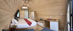 a small bedroom with a bed in a wooden wall at Puluong Valley Home in Thanh Hóa