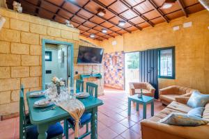 a living room with a table and a couch at Casa Rural Carmo in Carmona