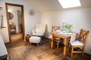 a dining room with a table and chairs at Penzion Pawlowitz in Velké Pavlovice +16 photos