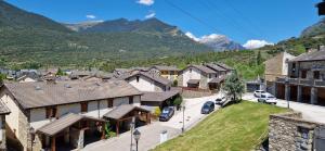 a small town with mountains in the background at Terrazas del Pirineo en Villanúa in Villanúa