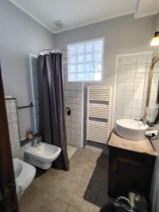 a bathroom with a sink and a toilet and a sink at In Piazzetta - Cernobbio in Cernobbio +19 photos