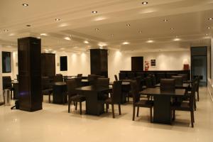a dining room with black tables and chairs at Hotel Solar Norte in San Miguel de Tucumán