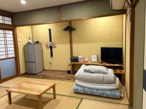 a living room with a bed and a refrigerator at SABOJI - Vacation STAY 34252v in Takamori