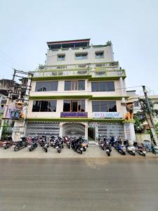 a group of motorcycles parked in front of a building at Jagannath Palace in mayapur