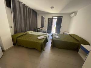 En eller flere senge i et værelse på Hotel San Martino