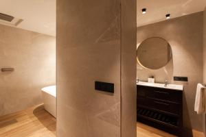 a bathroom with a shower with a sink and a mirror at Welldone Sierpes Boutique in Seville