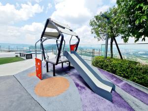 a playground with a slide on a building at Duplex City Center Eko Cheras Mall KLCC Tun Razak Exchange Mall in Kuala Lumpur