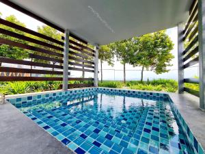 a swimming pool in a house with blue tiles at Duplex City Center Eko Cheras Mall KLCC Tun Razak Exchange Mall in Kuala Lumpur