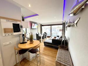 a living room with a table and a couch at Ferienwohnung Strandperle - nur 150m zum Strand in Scharbeutz +12 photos