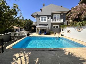 a house with a swimming pool in front of a house at VİLLA MARMARİS in Marmaris