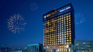 a tall building with fireworks in the sky at Shilla Stay Dongtan in Hwaseong