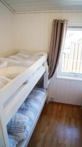 a bedroom with a bunk bed and a window at Sommerstua - Nes Camping in Moss