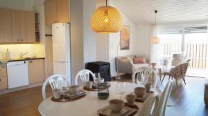 a kitchen and living room with a table and chairs at Sommerstua - Nes Camping in Moss