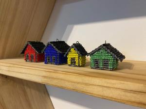 a group of small houses on a shelf at Beach Hut Empire Apartment in Muizenberg +28 photos