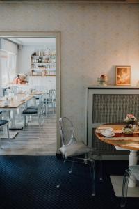a dining room with tables and chairs and a fireplace at Hotel Dreieich in Langen +17 photos