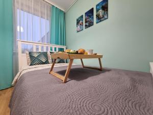 a bedroom with a bed with a table on it at Pokoje Częstochowa in Częstochowa