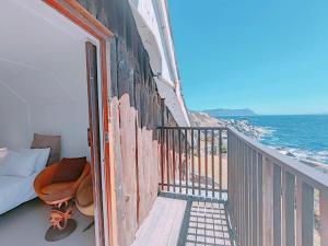 a balcony with a view of the ocean at Timber's Ocean House in Simonʼs Town +113 photos