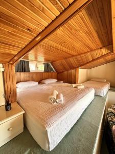 a bedroom with a bed with slippers on it at VİLLA MARMARİS in Marmaris