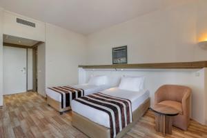 Postel nebo postele na pokoji v ubytování Green Max Hotel