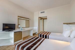 Postel nebo postele na pokoji v ubytování Green Max Hotel