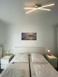 1 dormitorio con 2 camas y 2 mesitas de noche en Villa Döser Strand, en Cuxhaven