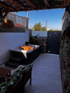 a man in a bath tub on a patio at City Compass Luxury Suites Faliraki in Faliraki