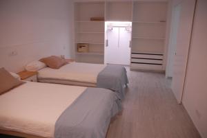 Posteľ alebo postele v izbe v ubytovaní Neptuno Suites - Adults Only + 37 fotografií