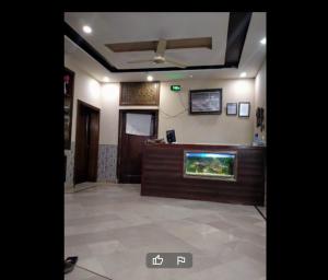 a lobby with a fish tank on a counter at Garden View Hotel in Lahore